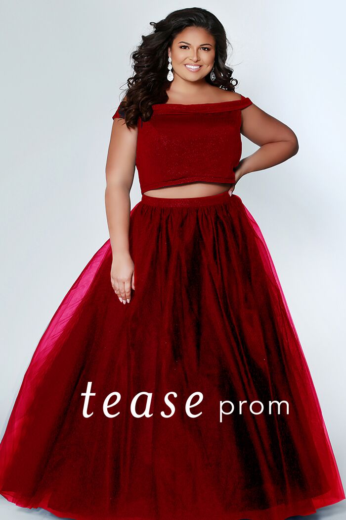 TE1909  Be a trend setter at Prom wearing a monochrome two-piece plus size dress. Sparkly red or blue off-shoulder top and tulle skirt with curly horsehair hem. Crop-top and waistband in matching light-red sparkle-embedded fabric. This dress is right on trend for prom.